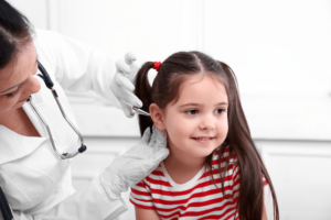 Doctor examining child's ears