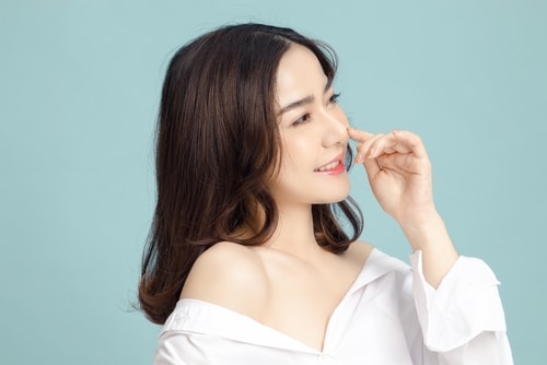 Beautiful,Short,Hair,Asian,Woman,Model,Touch,Her,Nose,And