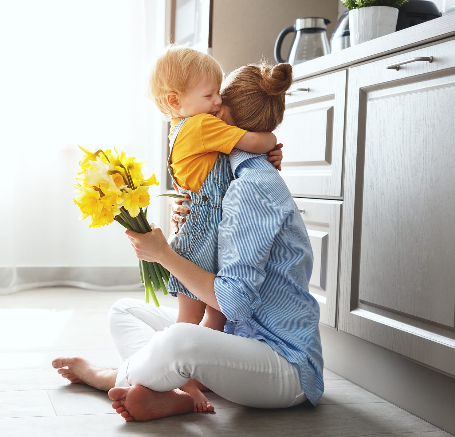 happy mother's day! baby son gives flowersfor mother on holiday