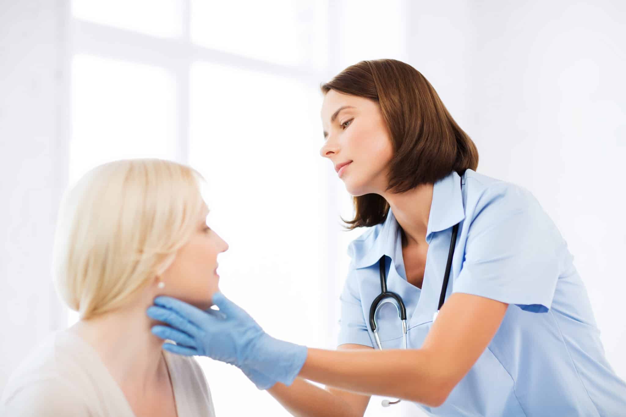 plastic surgeon or doctor with patient