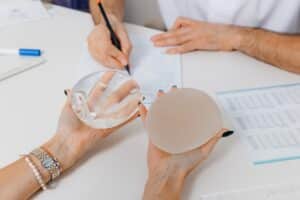 Woman having a consultation with her cosmetic surgeon to choose between silicone and saline breast implants