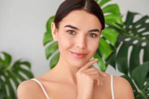 Woman with clear, glowing skin after microneedling.